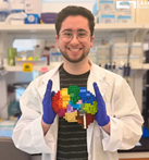 Max Bucklan holding a Lego Set in Shape of Brain